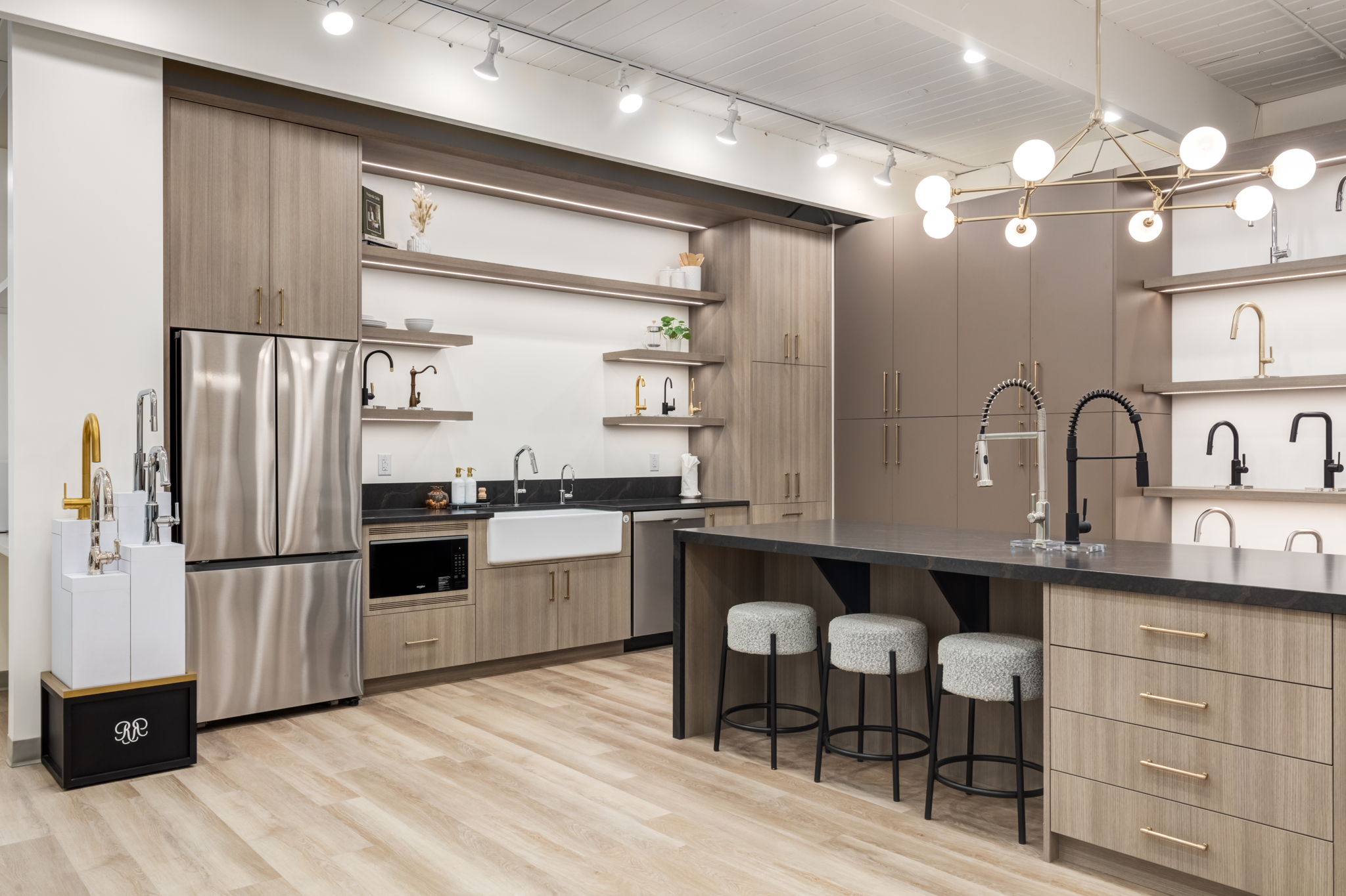 Luxury kitchen showroom with designer faucets and modern cabinetry