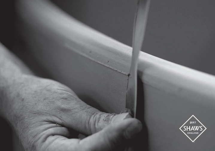 Artisan hand-finishing a fireclay sink